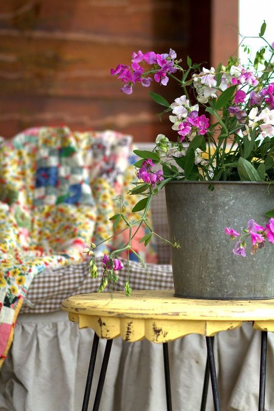 rustic log home porch decor using sweet pea wildflowers, decks, home decor, porches, Galvanized bucket with wild SweetPeas