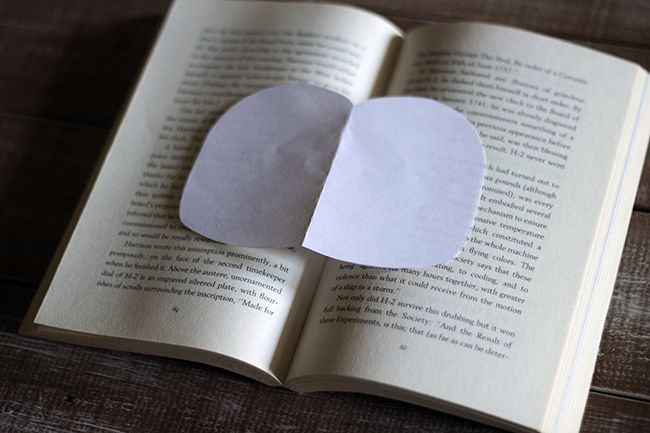 calabazas de libros de papel diy, Abre el libro por la mitad y coloca la plantilla de papel encima con el centro de la calabaza coincidiendo con la encuadernaci n central del libro