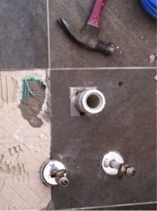 beware of work done on or near radiant heated floors, flooring, tile flooring, We can see where holes have been drilled into the tile with 2 direct hits to the wire Another risk factor to severing the wires of your Radiant Heating System is all about timing
