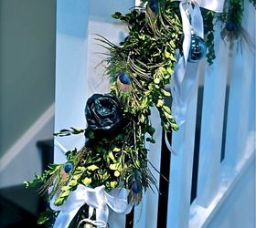looking for holiday decor inspiration how about peacock feathers, seasonal holiday decor, I wanted to use fresh boxwood garland on the banister It is a long staircase so to fill it up I made roses out of wound up tissue paper a very cost effective trick I have used over the years