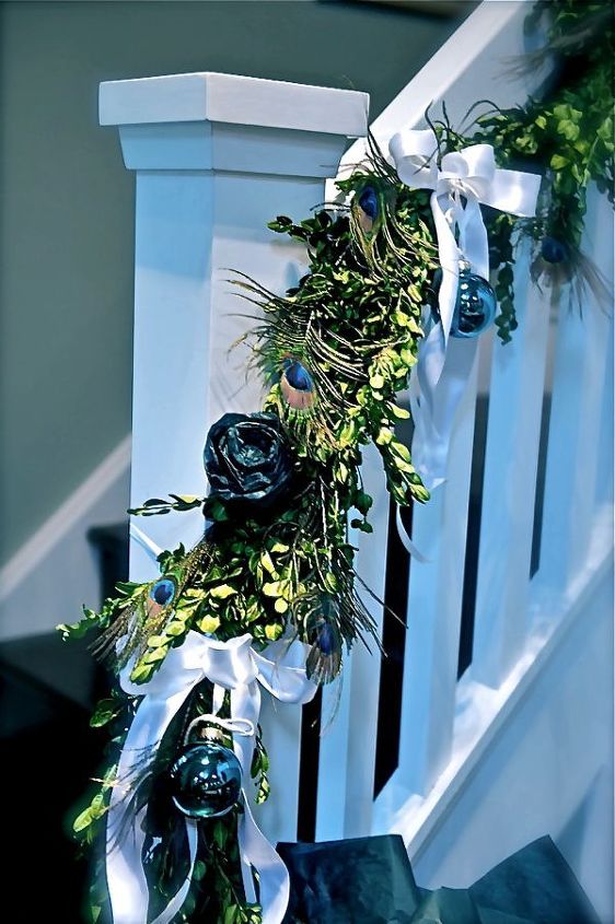 looking for holiday decor inspiration how about peacock feathers, seasonal holiday decor, I wanted to use fresh boxwood garland on the banister It is a long staircase so to fill it up I made roses out of wound up tissue paper a very cost effective trick I have used over the years