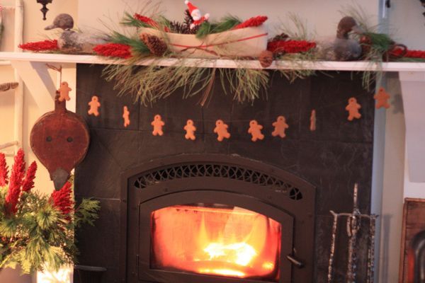 a rustic mantel and a cozy fire the family room at hoop top house decked out for, seasonal holiday d cor, gingerbread men on fishline