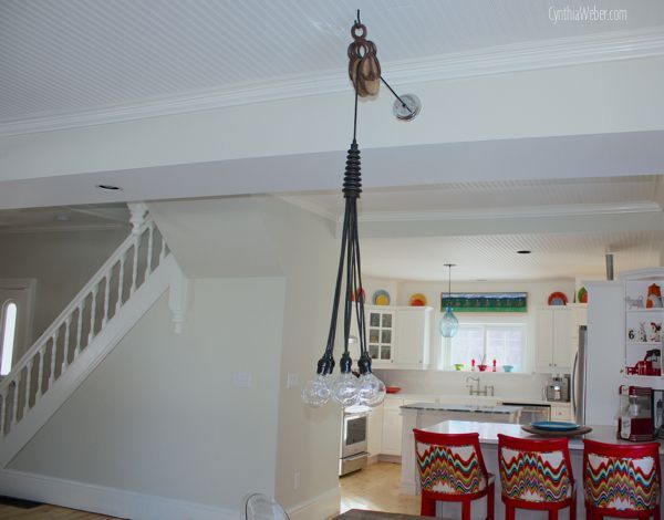 fun and cheery cottage kitchen reno, countertops, home decor, home improvement, kitchen backsplash, kitchen design, kitchen island, An antique pulley adds interest and swag to this industrial inspired dining light