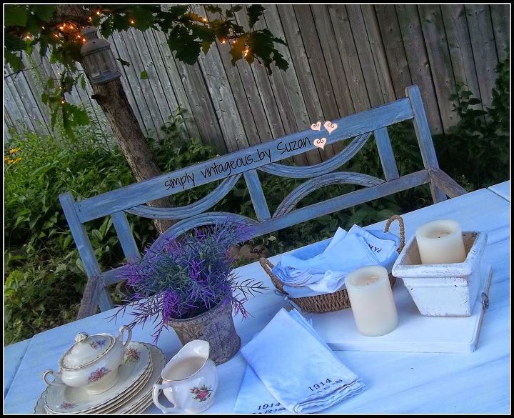 uma mesa ao ar livre caiada de branco e luzes de fadas