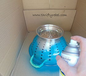 She spray paints a strainer for this almost magical outdoor decor idea