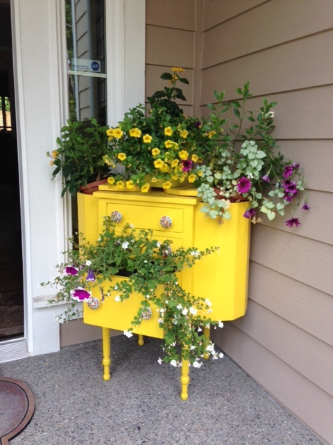 vintage sewing cabinet turned porch planter
