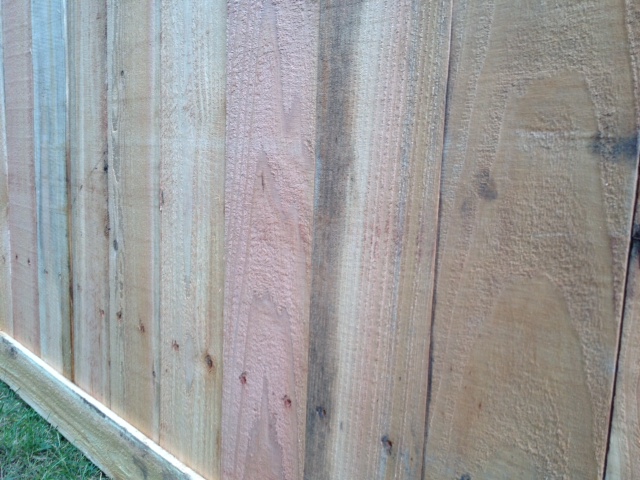how to correct poorly installed wood fence, Good nieghbor side of fence shows hail hole from bottom rail on inside of fence Rail was placed for another style of fence which probably would have hid these marks