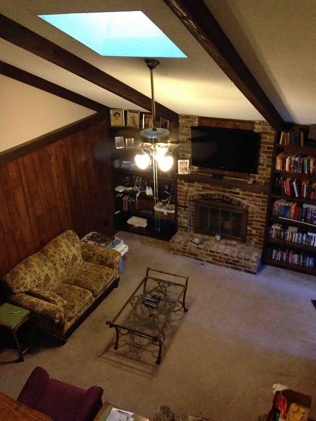 what to do with paneling in a dated living room, East wall The skylight shaft goes up 5 to 7 feet to the roof so the light makes the dark living room feel more like a dungeon with a oubliette hatch than a gathering place