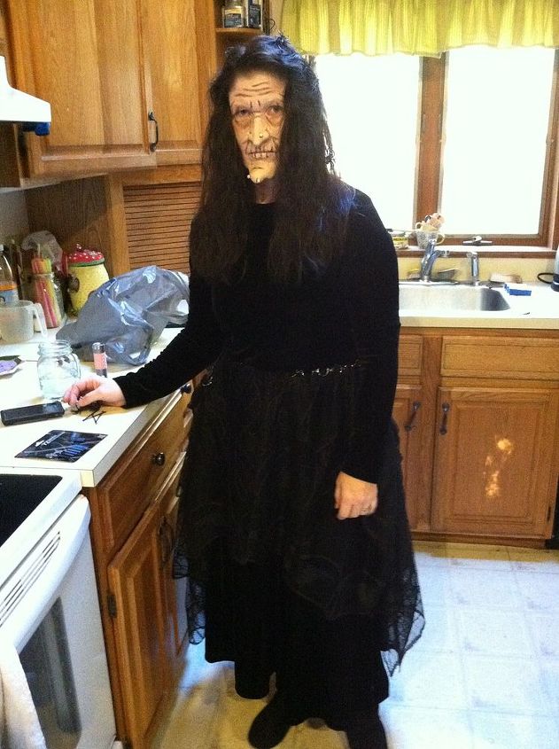 q kitchen cabinets staining wood change, kitchen cabinets, kitchen design, painting, Excuse the witch I had just done my sister s Halloween makeup in this picture but you can see the cabinets I am talking about and the color of the trim that is everywhere in my house around the window