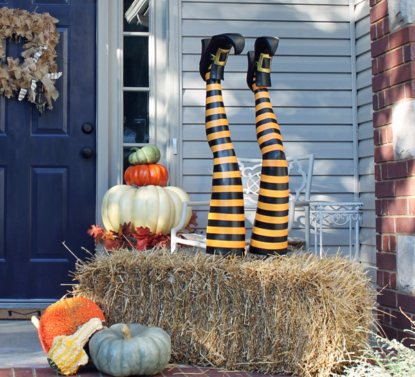 halloween decorations witch legs hay bale, halloween decorations, porches, seasonal holiday decor