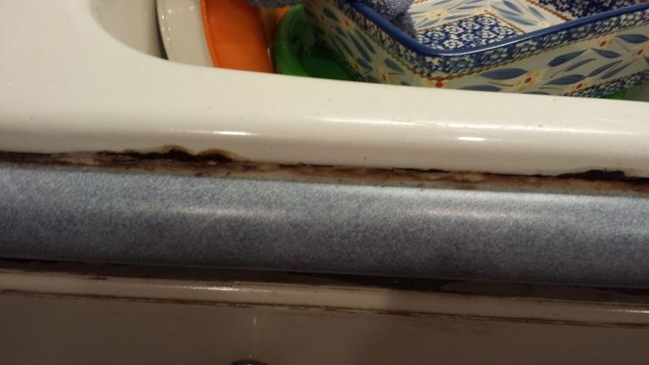 replace kitchen sink caulk, This is in front it almost looks like it is rusted