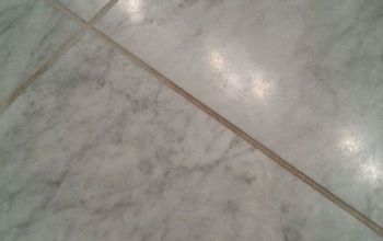 What do you use to clean grout on a honed marble floor?