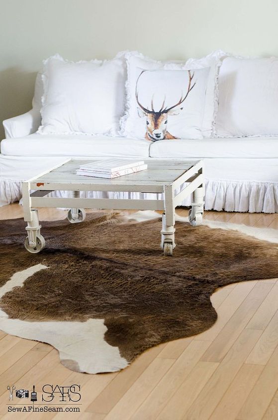 chandeliers and cow hide rugs in white living room decor, home decor, lighting, living room ideas, repurposing upcycling, reupholster