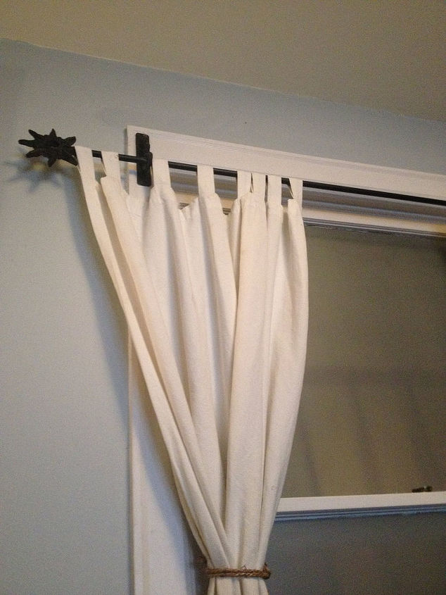 curtain placement previous owner screwed brackets into window trim