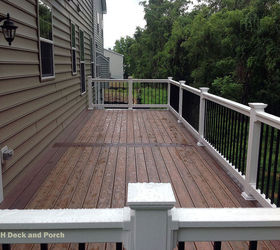 low maintenance decks, decks, outdoor furniture, outdoor living, Vinyl deck using Wolf amberwood decking with rosewood border and Longevity white PVC railing with black balusters