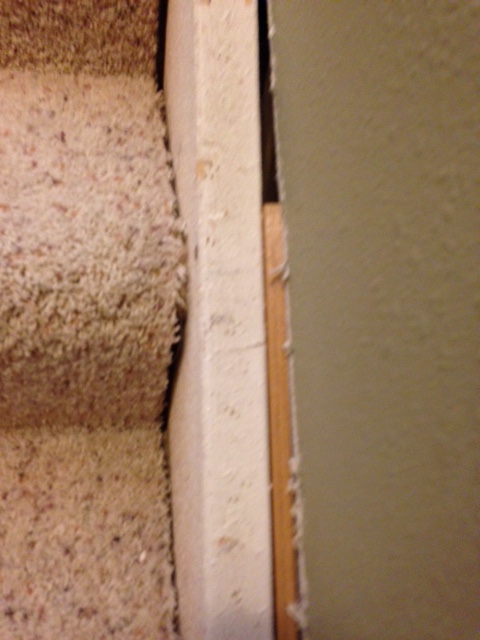 skirt board on stairs all screwed up under the carpeting