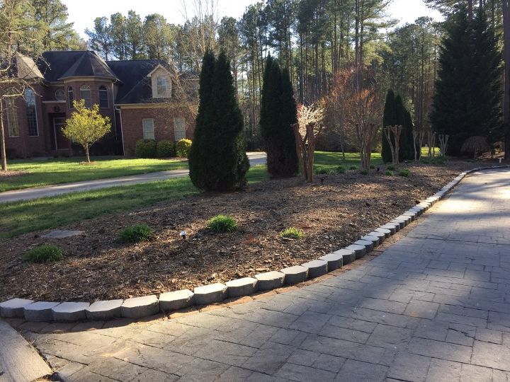 q what type of plants and decor can work for the curb appeal of my house, curb appeal, flowers, gardening, ponds water features, raised garden beds, A raised flower bed runs along the driveway Need help with flowers to add a curb appeal