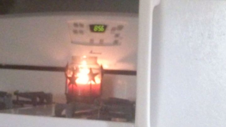 q burning candles in glass jars on stovetop, appliances, lighting