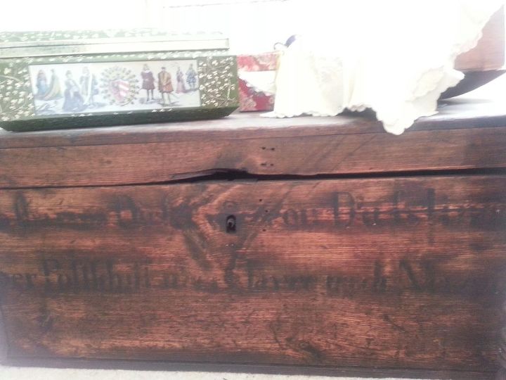 have an antique wooden trunk with painted writing on it, Shows front of truck with writing barely visible