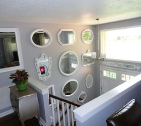 bland split foyer entry to wow wall of thrift store mirrors, View from living dining room