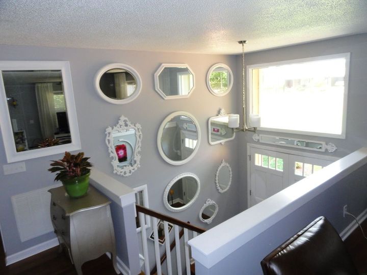 bland split foyer entry to wow wall of thrift store mirrors, View from living dining room