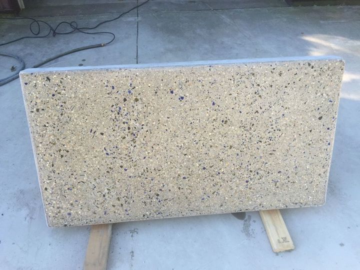 back yard coffee table top made of concrete with crushed wine bottles