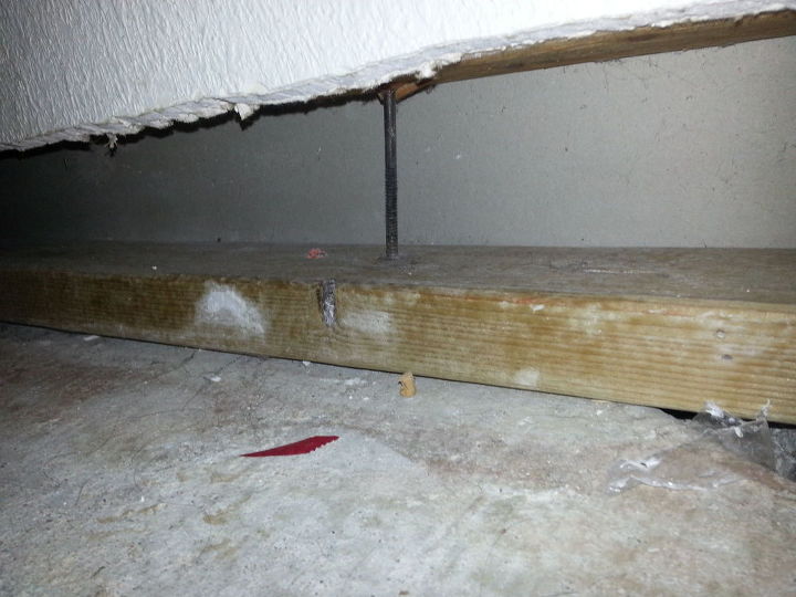 q basement foundation settling, basement ideas, home improvement, home maintenance repairs, bottom of stairs this pic makes it look straight but this nail is tilted because of the wall settling Bottom of stairs floor board I don t mess with this one because it might be a specific set up for fire code