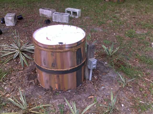revamped the rain barrel sprinkler, gardening, outdoor living, plumbing, I then cut the barrel and placed the top over the pipes to be covered