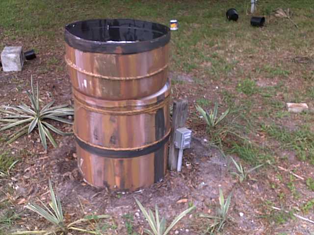 revamped the rain barrel sprinkler, gardening, outdoor living, plumbing, I then placed the bottom on the top of the cut barrel and touched up the paint