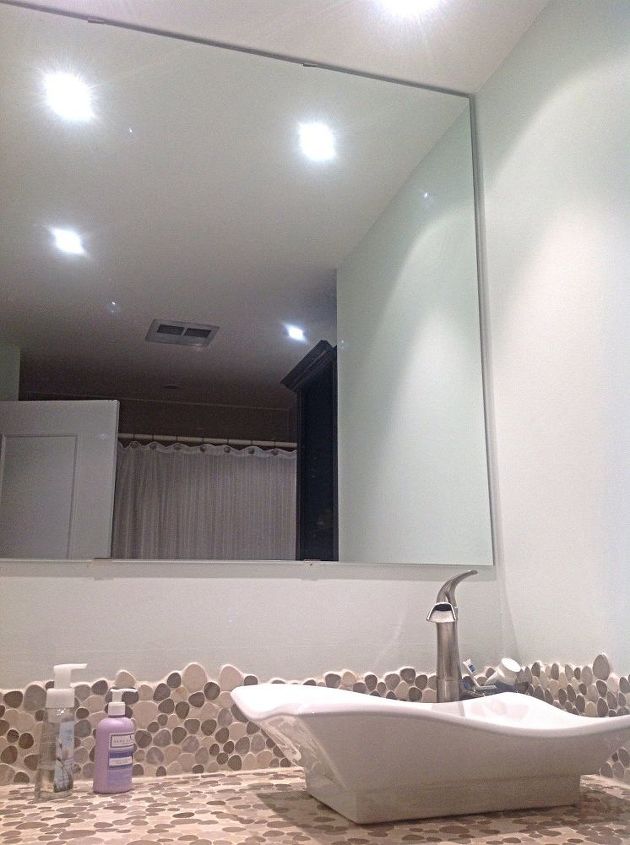 bottom of large mirror looks disconnected from backsplash counter, Mirror goes to ceiling Love effect of pebbles but my eyes just go towards the disconnected space between backsplash and mirror