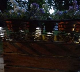 an apple box rusted out mattress springs solar lights cuteness, container gardening, flowers, gardening, repurposing upcycling, Side view at dusk