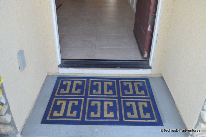 give a worn out rubber mat a new life with spray paint and stencil, crafts