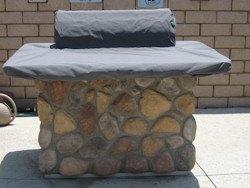 grill island covers, outdoor living, Outdoor gas grill with a stone base covered with a black grill cover top
