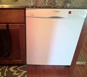 White dishwasher in a stainless steel kitchen