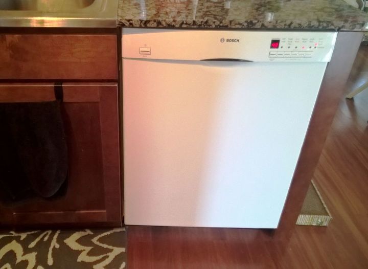 white dishwasher in a stainless steel kitchen