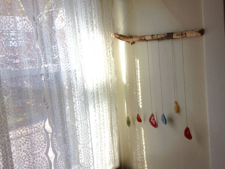 yay or nay on this vintage 1970s headboard, A colorful agate mobile made from a branch is another decoration We have delicate lace curtains that reflect dancing shadows on the wall