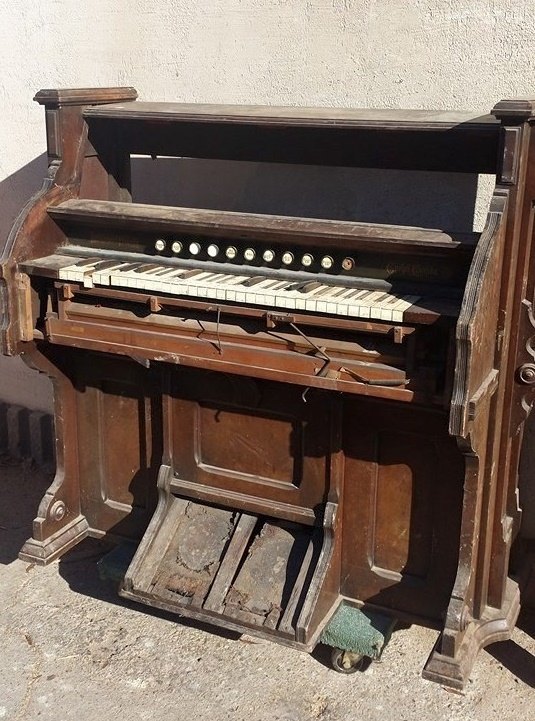 1800 s eastlake pump organ repurposed into a wine bar
