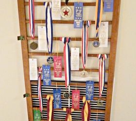 an old crib railing becomes a great place to display ribbons and hide an ugly wall, repurposing upcycling, wall decor, Cover an ugly wall vent get creative by using an old crib railing to display award ribbons