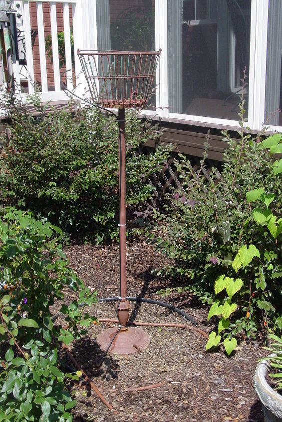old wire egg basket and thrift store floor lamp stand repurposed into an outdoor