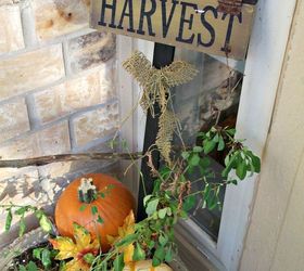 decorating the front porch for fall, home decor, seasonal holiday decor, A couple of pumpkins and a harvest yard sign take the potted plant from Summer to Fall