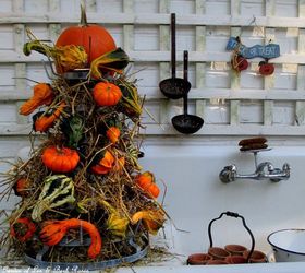 tower of gourds, seasonal holiday d cor, Our outside potting sink is decked out for Fall with a Gourd Tower made with gourds and pumpkins stuck on a wire bottle rack and filled in with hay