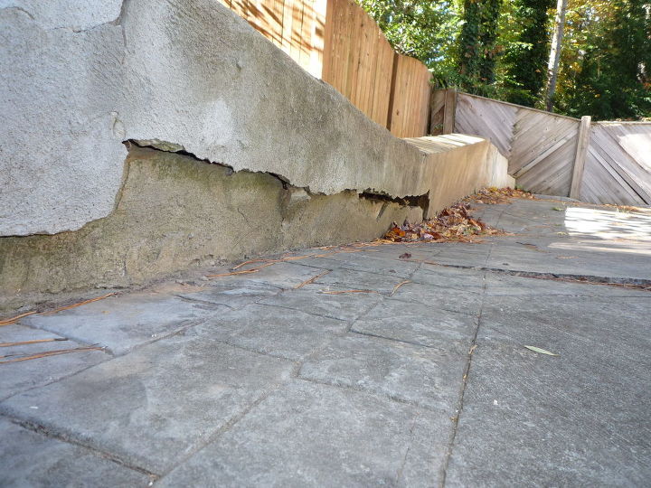 sink hole under driveway retaining wall