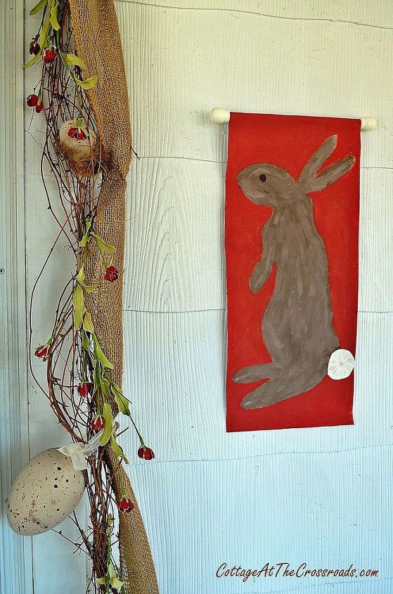 decorating the front porch for easter, easter decorations, seasonal holiday d cor, I used a grapevine and burlap garland around the front door and painted some bunnies onto an old canvas