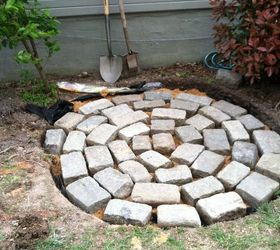 recycled granite block patio, outdoor living, patio, I dug my hole about 3 4 inches deeper than the stones I covered the base of the hole with a layer of weed block fabric then 2 3 inches of sand I laid out stones in a circular pattern starting in the center