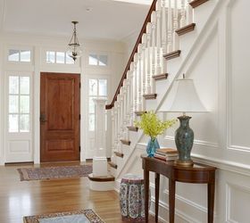 details details how you can add character and pizazz to your home, home decor, The paneling throughout this entryway is so clean and crisp painted white Love the stained wood door and railings Nice pop of color
