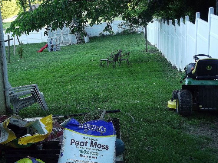 sloped backyard, diy, how to, landscape, Again excuse the mess from the gate looking into the backyard The set of chairs are under a tree that starts to be shaded around noon Will eventually be adding to that as well