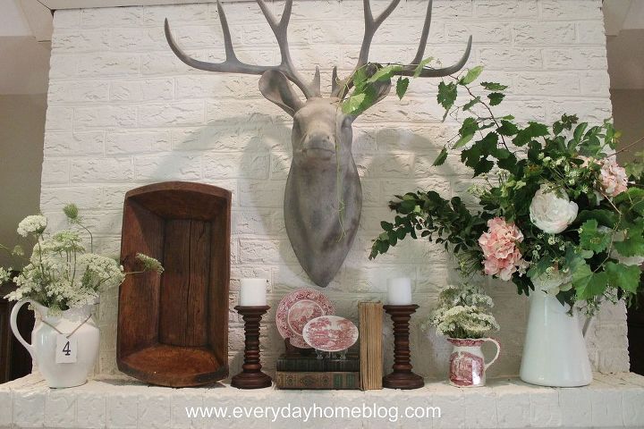 how to create a summertime mantel for free, flowers, home decor, Buck looks over a mantel filled with lacy white blossoms white farmhouse pitchers and pink and white Stafforshire dishes