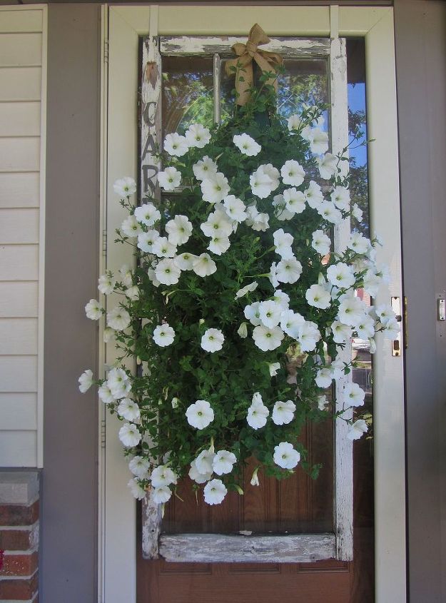 vintage summer garden, flowers, gardening, outdoor living, repurposing upcycling, This is an old vintage door that I actually hung on my front door and then added a bag of flowers and a chippy garden sign I love this old door acting as a frame for the flowers