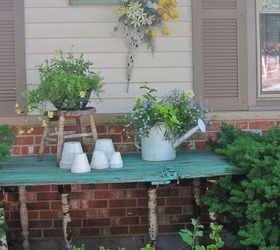 vintage summer garden, flowers, gardening, outdoor living, repurposing upcycling, This is an old barn door that was made into a potting table for the garden I love the color and the how much space this gives me to re pot plants Just adds some whimsy to the garden