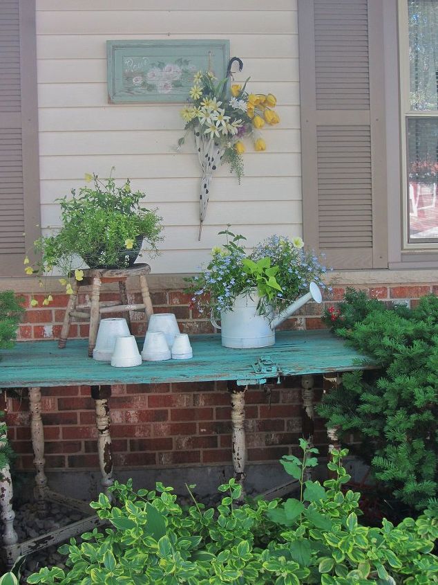 vintage summer garden, flowers, gardening, outdoor living, repurposing upcycling, This is an old barn door that was made into a potting table for the garden I love the color and the how much space this gives me to re pot plants Just adds some whimsy to the garden